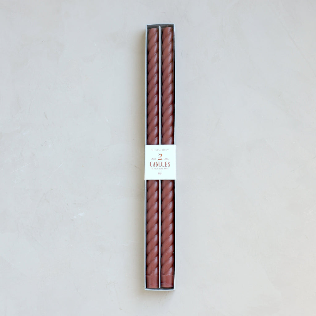 Our Fancy Taper Candles are hand-molded and embody a superior depth of color. A cotton wick is used for the cleanest burn, and the base is sized to fit a standard holder. Each 18” candle is crafted to burn for eighteen hours. Subtle variations in wax depth and color opacity may occur.  Two 18” candles per pack. Standard 7/8” base. Made of high grade paraffin wax. Clay color braided taper