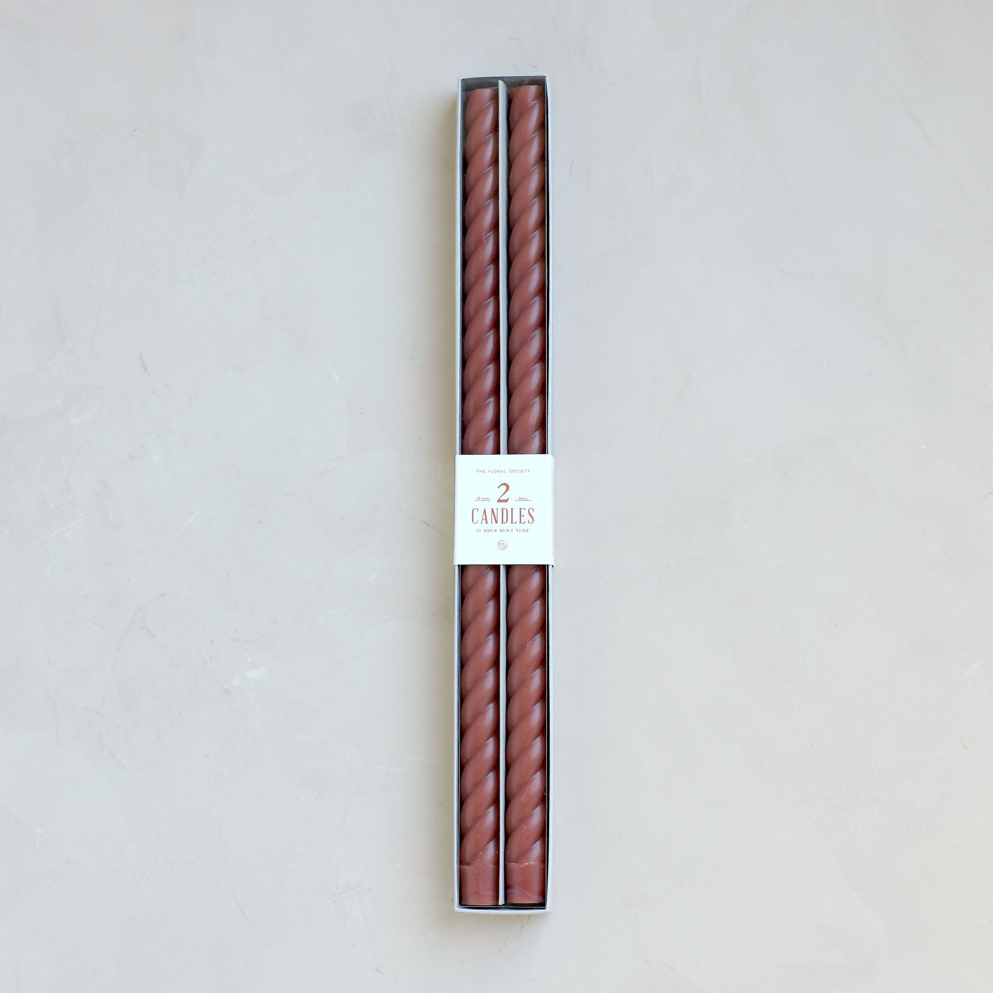 Our Fancy Taper Candles are hand-molded and embody a superior depth of color. A cotton wick is used for the cleanest burn, and the base is sized to fit a standard holder. Each 18” candle is crafted to burn for eighteen hours. Subtle variations in wax depth and color opacity may occur.  Two 18” candles per pack. Standard 7/8” base. Made of high grade paraffin wax. Clay color braided taper