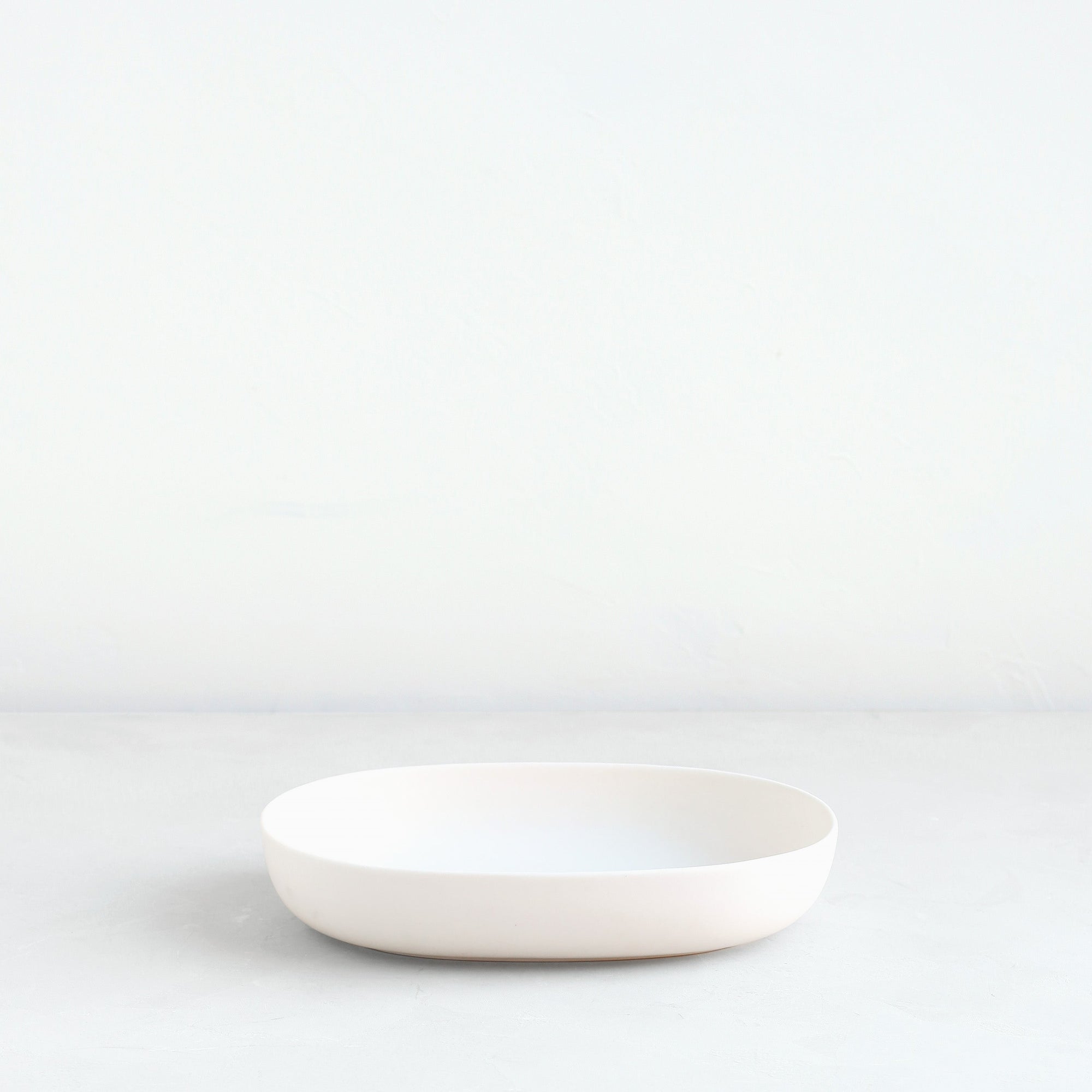 The oval dish is the perfect companion to the oval flower frog or a traditional pin frog. Designed to display a minimal selection of blooms, the oval dish can also be used as a catch-all tray, a fruit bowl or a serving platter. Smaller in scale but identical in form, the dish pairs perfectly with the “ceramic flower frog bowl & taper holder” for a seamless, sculptural tabletop. Food, Microwave, dishwasher and oven safe.