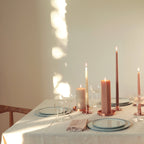 Dipped taper candles in muted colors. Pillar candles and copper candleholders