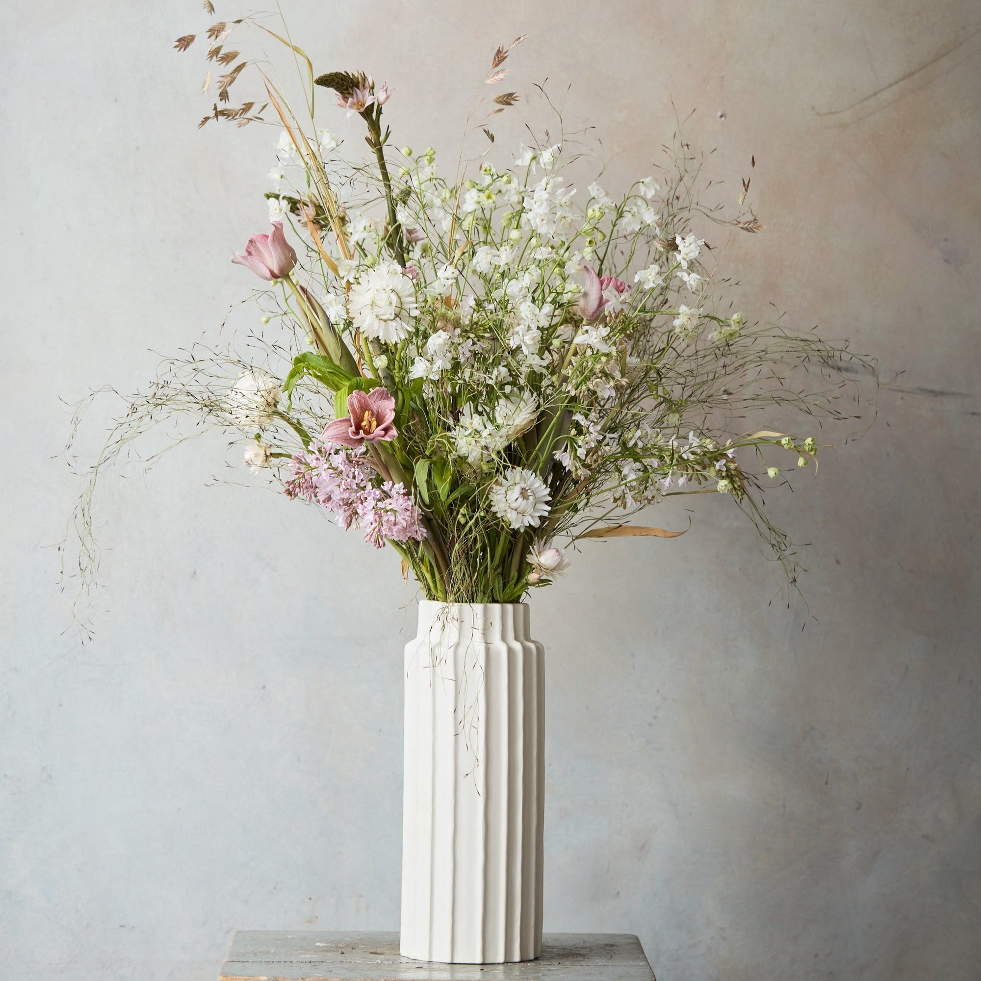 Our ceramic cylinder vases invite you to reconnect with the wild bounty of nature, providing the perfect vessels for a foraged handful or a farmer’s market bunch. Inspired by organic linear forms found in nature, use them for impromptu and loose arrangements or for displaying dried botanicals through the colder months.