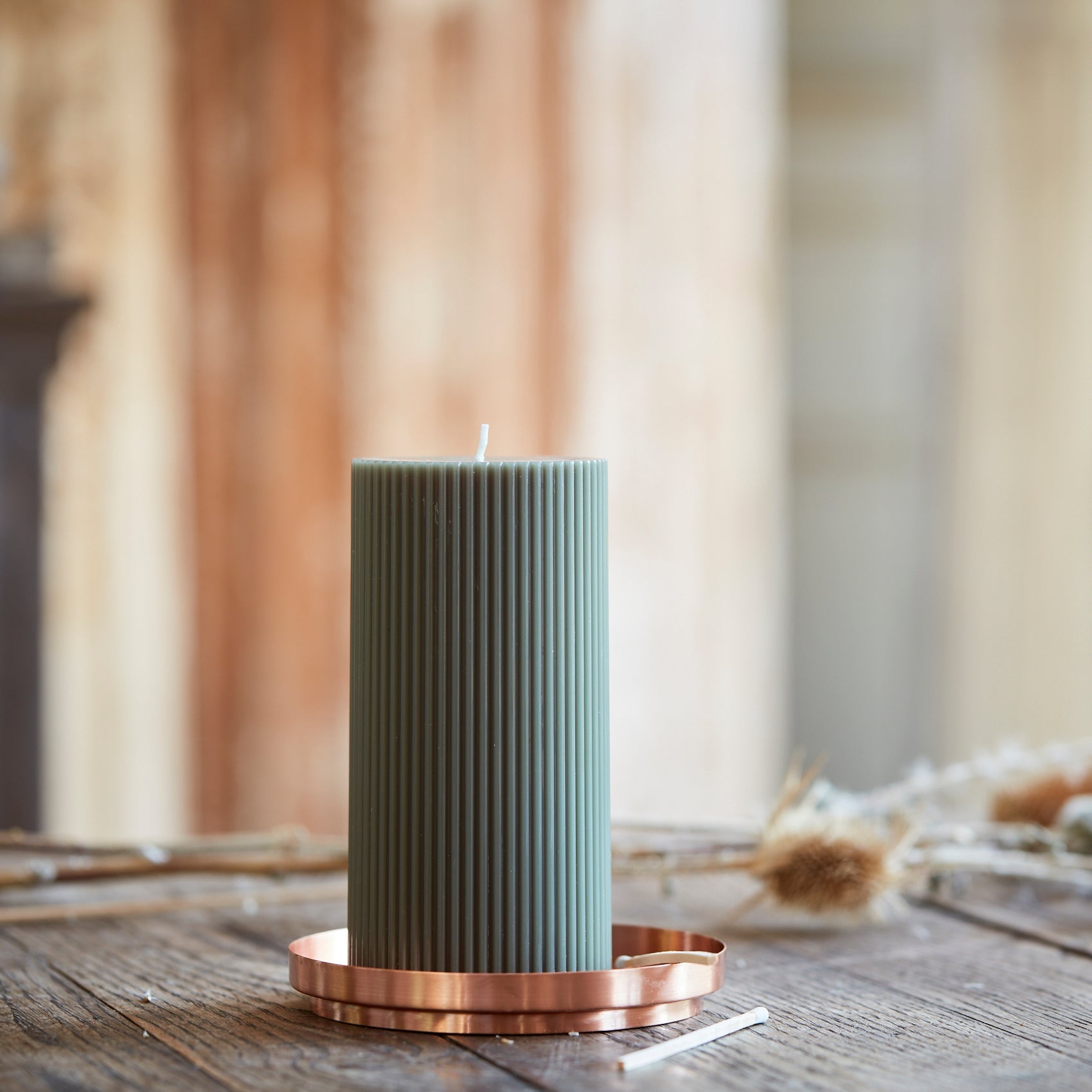 Our 3x6 ribbed pillar is a modern take on a traditional candle and embodies a superior depth of color, a cotton wick, and a 70-hour burn time.  Subtle variations in wax depth and color opacity may occur. Available in 4 custom colors: Parchment, Moss, Petal & Clay.  Dimensions: 3”W x 6”H